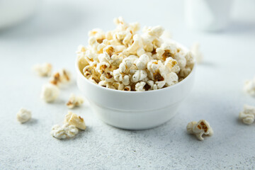 Homemade salted popcorn in a white bowl