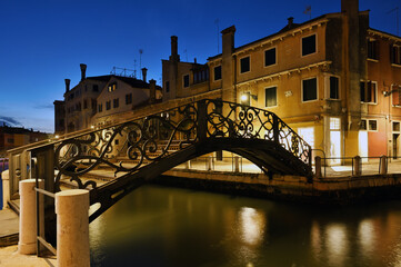 Fototapeta na wymiar Architecture and small canal at evening in Venice, Italy