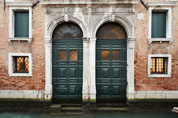 Doors and windows over canal in Venice, Italy