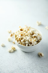 Homemade salted popcorn in a white bowl