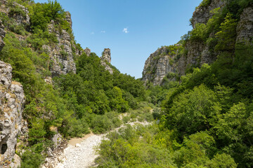 Fototapeta na wymiar Daytime view of Vikos Gorge from the Oxya Viewpoint in the park national of Vikos-Aoos in northern Greece