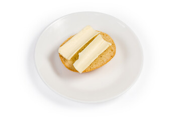 Open sandwich with butter on saucer on a white background