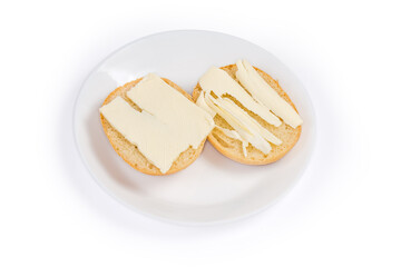 Open sandwiches with butter on dish on a white background