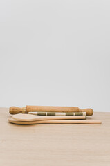 natural wood kitchen tools and table napkin on a wooden tabletop
