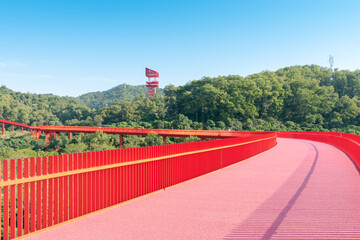 An outdoor park with a red bridge in Shenzhen, China
