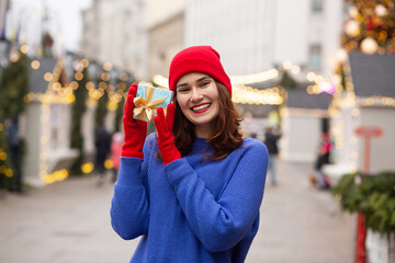 Lovely lady receiving gift in a box at the New Year eve