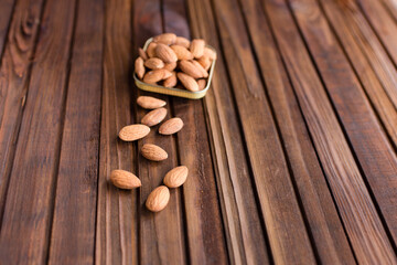 almonds in a bowl on a wooden background	