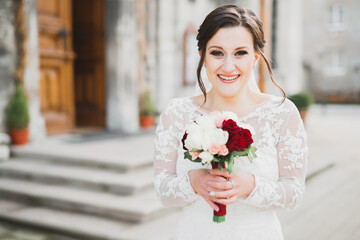 Bride holding big and beautiful wedding bouquet with flowers