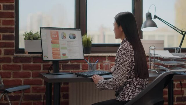 Entrepreneur suffering from back pain at office desk, trying to plan business project in discomfort. Worker with backache feeling overworked at startup job. Stressed woman in pain.