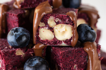 Pieces of beetroot brownie with blueberries, nuts and chocolate. Sugar, gluten and lactose free and vegan.