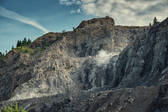 picture of mining in a quarry with demolition equipment, industrial photography, mining and environmental destruction
