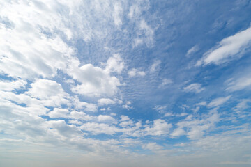 Clear blue sky with white fluffy clouds at noon. Day time. Abstract nature landscape background.