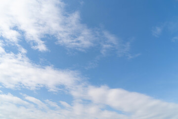 Clear blue sky with white fluffy clouds at noon. Day time. Abstract nature landscape background.