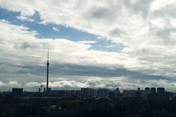 RUSSIA, MOSCOW: Scenic sunny day landscape view of the city garden with Ostankino tower and blue clouds in the background 