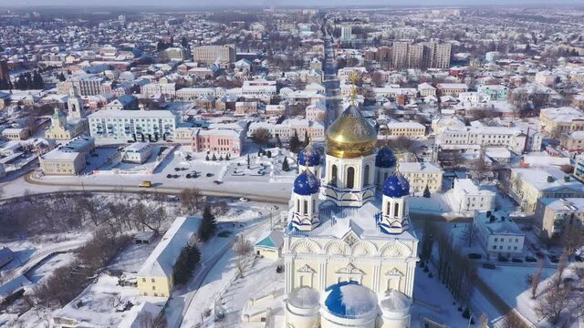 Aerial view of the Ascension Cathedral, located in the historical center of the city on the Red Square of Yelets, and the surrounding his residential areas in winter, Russia.