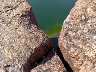  set of rocks and green algae on a turquoise blue river in finland