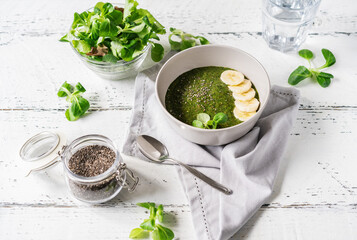 Green porridge in bawl with ingredients