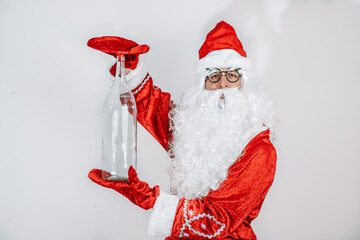 Santa Claus holding a bottle. Glass transparent bottle.