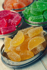 Dessert marmalade in the form of lemon and orange slices. The sweetness of jelly candy.