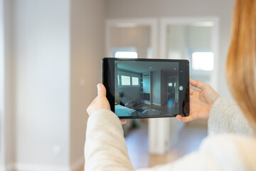 Real estate agent conducts virtual tour to show a property to clients via video call. High quality...