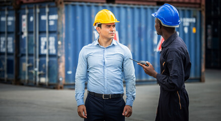 Caucasian man and African American man staff. Inspector of Container at the port.