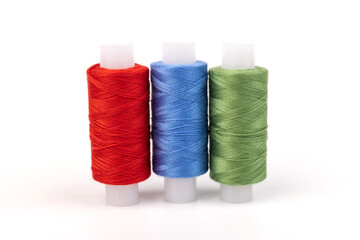 Color sewing threads isolated on white background. Different colors.Bright bobbin thread.