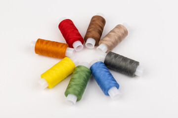 Color sewing threads isolated on white background. Different colors.Bright bobbin thread.