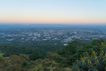 Aerial view of Chiang Mai Downtown Skyline, Thailand. Financial district and business centers in urban city in Asia. Skyscraper and high-rise buildings on mountain hill at sunset.
