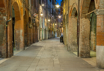Fototapeta na wymiar Ferrara - The street of old town at dusk.