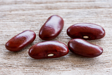 Group of red kidney bean isolated on wood table background.