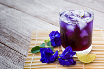 Butterfly pea or blue pea juice ice tea and clitoria ternatea flowers with green leaf isolated on...