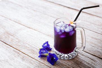 Butterfly pea or blue pea juice ice tea and clitoria ternatea flowers with green leaf isolated on...