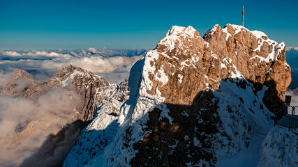 Beautiful alpine HDR summer view with the summit cross of the famous Zugspitze summit, top of...
