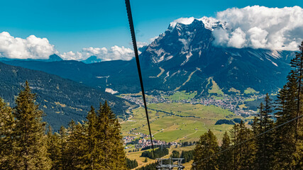 Beautiful alpine summer far view of the famous Zugspitze summit seen from the Grubigstein summit...