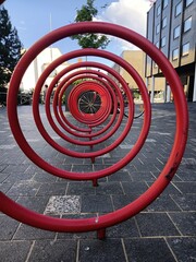 frontal shot of a red spiral of a bicycle parking