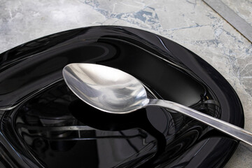 A spoon on an empty plate closeup