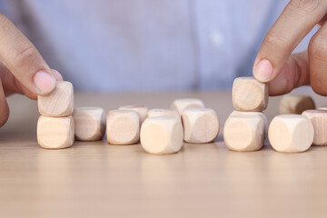 Hand holding wooden cube on wooden table, mockup, template, copy space for text