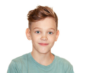 a boy with a tousled hairstyle is smiling at the camera © Ольга Потылицына