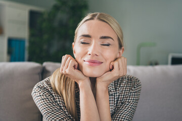 Fototapeta premium Portrait of charming lovely lady sit comfy divan touch hand chin enjoy holiday vacation in house apartment