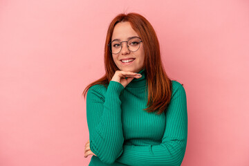 Young caucasian woman isolated on pink background smiling happy and confident, touching chin with hand.