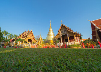 Fototapeta premium Wat Phra Singh Woramahawihan golden pagoda or stupa of buddhist Temple, Chiang Mai City, Thailand. Thai architecture. Tourist attraction landmark.