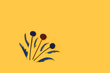 Flower branch on a yellow background. Copy space. View from above. Empty space for quotes, text, aphorisms