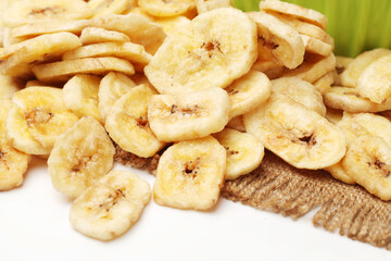 Banana chips on white background