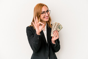 Young business caucasian woman holding banknotes isolated on white background cheerful and...