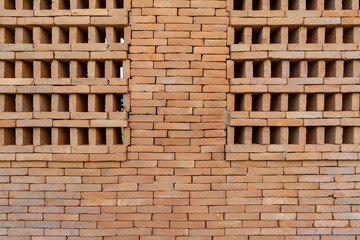 The new pattern of hole brick wall arrangement art with modern and vintage combination style for creative wall background design.