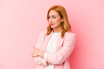 Young caucasian woman isolated on pink background unhappy looking in camera with sarcastic...