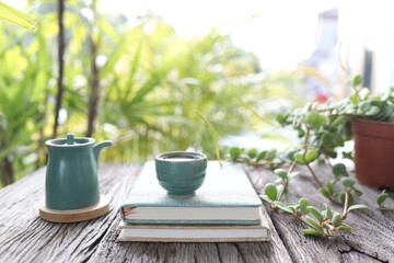 Blue ceramic tea cup and vintage teapot and flowers