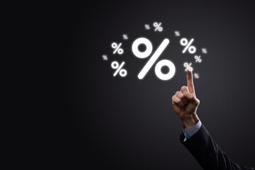 Male hand holding interest rate percent icon on blue background. Interest rate financial and mortgage rates concept.Banner with copy space