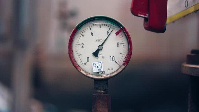 Dark surface with a deep reflection of pressure gauges.manometer in focus. A pressure gauge on the background of other instruments.