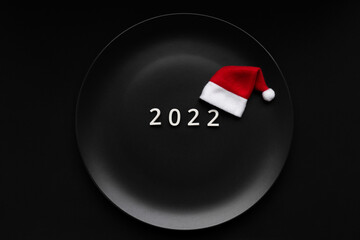 Numbers 2022 on a plate, conceptual photo. New Year's table decoration.